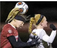  ?? NWA Democrat-Gazette/BEN GOFF ?? Arkansas’ Parker Goins (left) wins a header over UALR’s Claire Palmer during Friday night’s NCAA Women’s Soccer Tournament match at Razorback Field in Fayettevil­le.