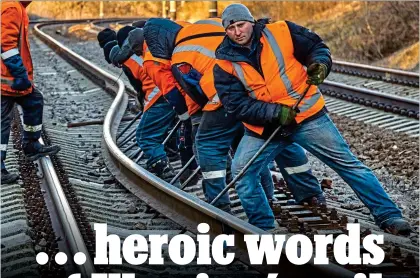  ?? ?? HARD GRAFT: Ukrainians fix a bent track near the Russian border last week