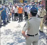  ?? ANSHUMAN POYREKAR/HT ?? People gather outside the ST bus depot in Parel after rumours that services were about to start from Monday.