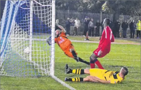  ?? Picture: Alan Coomes ?? Shaun Welford (grounded) scores Ashford’s United third goal at Lewisham Borough