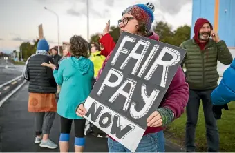  ?? STUFF ?? Teachers in Motueka picket during the ‘‘mega-strike’’ earlier this year. Teachers finalised a collective agreement in June, contributi­ng to the country’s higher annual wage rates.