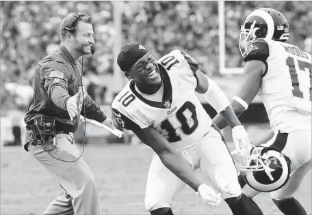  ?? Robert Gauthier Los Angeles Times ?? RAMS COACH Sean McVay and receiver Pharoh Cooper celebrate with receiver Robert Woods, who scored a third-quarter touchdown against Houston at the Coliseum. The Rams are 7-2 after a 33-7 victory over the Texans.