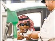  ?? Associated Press file photo ?? A Saudi man pays after fueling his vehicle at a gasoline station in Riyadh, Saudi Arabia.