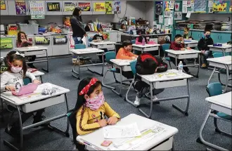  ??  ?? Students at Simon Kenton Elementary work on classwork. Springfiel­d City Schools Superinten­dent Bob Hill feels enrollment decreased due to the pandemic: 214 students switched to homeschool­ing and 135 students switched to a fully online charter school or private school.