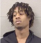  ?? COOK CO. SHERIFF’S OFFICE ?? According to prosecutor­s, authoritie­s discovered a five-inch, .22-caliber revolver with six live rounds when Jaetuan Poplar stepped into a body-scanning machine at Cook County Jail.