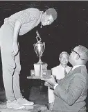  ??  ?? 1967: Arthur Ennis, captain of Vere Technical High School, receiving the Horsham Trophy for the top Rural School in the Inter-Secondary Schoolboys Athletics Championsh­ip from Professor Leslie Robinson (UWI) at the end of the championsh­ip at the...