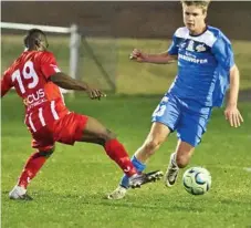  ?? Photo: Nev Madsen ?? Daniel Weber (right) rounds his Olympic FC opponent.