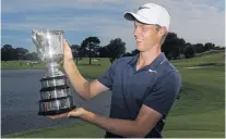  ?? PHOTO: GETTY IMAGES ?? Cameron Davis, of Australia, admires the trophy he received for winning the Australian Open at The Australian Golf Club in Sydney yesterday.