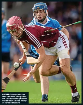  ??  ?? FOCUS: Galway defender Declan Cronin tries gather the sliothar under pressure from Dublin’s Seán Treacy at Semple Stadium