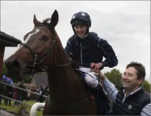  ??  ?? A special moment for Conor O’Dwyer (right) after his 17-year-old son, Charlie, had his first win as a jockey last June aboard Roses Queen.