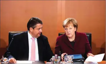  ?? STEFFI LOOS/AFP ?? German Chancellor Angela Merkel (right) sits with German Vice Chancellor and Economy and Energy Minister Sigmar Gabriel.