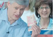  ?? JONATHAN HAYWARD/THE CANADIAN PRESS ?? Stephen Harper illustrate­s proposed Liberal tax hikes during a campaign event. Geoff Norquay says Harper’s platform was “static, defensive and uninspirin­g.”