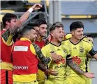  ??  ?? The Wellington Phoenix celebrate scoring in their last outing, a 3-0 win over Melbourne Victory on March 15.