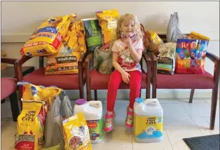  ??  ?? In lieu of birthday presents, Amelia Cambridge, 6, of Jacksonvil­le donated items to the Jacksonvil­le Animal Shelter. Amelia was inspired by the idea after her mom, Karen Cambridge, read her “The Miscalcula­tions of Lightning Girl.”