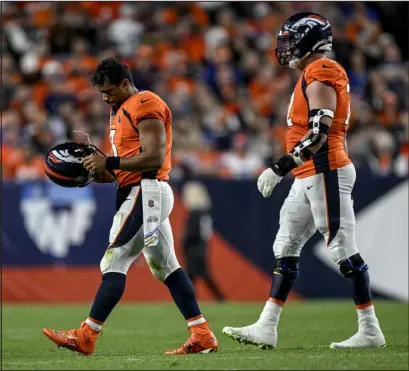  ?? AARON ONTIVEROZ — THE DENVER POST ?? Quarterbac­k Russell Wilson, left, and left tackle Garett Bolles walk off the field together during a game Oct. 6 at Empower Field at Mile High.
