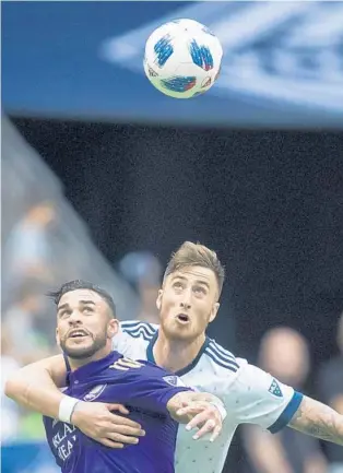  ?? DARRYL DYCK/ASSOCIATED PRESS ?? Lions striker Dom Dwyer, left, is covered by Whitecaps defender Jose Aja as they focus on the ball in Vancouver on Saturday. Dwyer and the Lions will try to snap a 5-match losing streak tonight in Montreal.