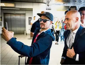  ??  ?? Say cheese: Ajax Amsterdam coach Peter Bosz (right) posing for pictures with a fan at the Schiphol Airport in Amsterdam yesterday. Ajax face Manchester United in the Europa League final in Stockholm today. — AFP