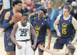  ??  ?? Colorado guard McKinley Wright IV, front left, flexes after putting in a basket on a rebound during the Buffs’ win over Cal on Thursday in Boulder.