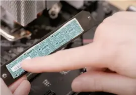  ??  ?? If your M.2 slot has a shield, check the back for a layer of thermal paste, covered by a small sheet of plastic. Leave that alone for now, and set aside the shield in a safe place for later use.