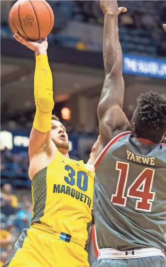  ?? JEFF HANISCH / USA TODAY SPORTS ?? Marquette guard Andrew Rowsey puts up a shot against St John’s forward Kassoum Yakwe on Tuesday.