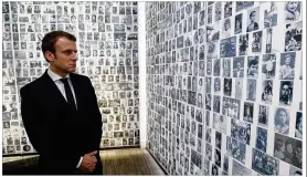  ?? PHILIPPE WOJAZER / ASSOCIATED PRESS ?? French presidenti­al candidate Emmanuel Macron looks at some of the 2,500 photograph­s of young Jews deported from France during his visit to the Shoah memorial in Paris on Sunday.