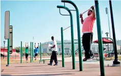  ??  ?? People work out in an outdoor exercise area at Macombs Dam Park in the Bronx section of New York City (REUTERS)