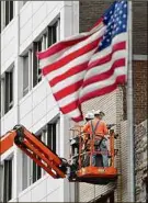  ?? Lori Van Buren / Times Union ?? Constructi­on workers are seen working on the exterior of a building on Washington Ave. on Flag Day on June 14 in Albany.