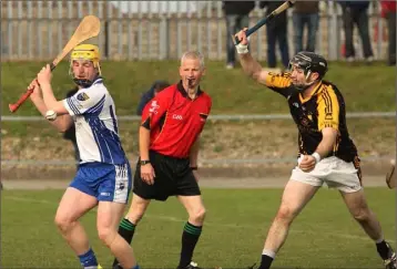  ??  ?? Referee Kevin Kehoe has the best view in the house as James Redmond strikes past James Delaney.