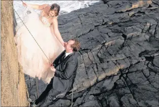  ?? GREG LOCKE PHOTOGRAPH­Y ?? Newlyweds Mandy and Steve O’keefe garnered plenty of attention when their photos of the bride and groom repelling down a cliff in Flatrock were recently posted on social media.