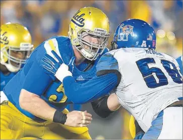  ?? Mark J. Terrill Associated Press ?? FALL CLASSES haven’t started at UCLA, leaving the Bruins free to focus exclusivel­y on football. Center Jake Brendel, left, blocking Memphis’ Terry Redden last year, says, “It’s kind of nice not to worry about school.”