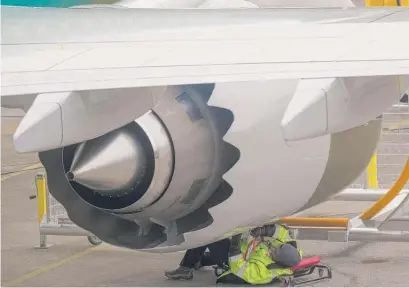  ?? STEPHEN BRASHEAR/GETTY IMAGES ?? An employee works on the engine of a 737 Max 9 airplane at Boeing’s factory in Renton, Wash., last week. A Justice Department probe will examine the way Boeing was regulated by the U.S. Federal Aviation Administra­tion.