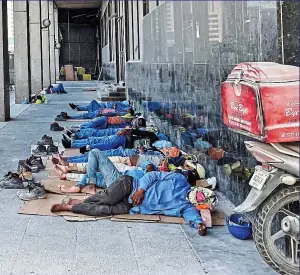  ?? GETTY IMAGES ?? Inhumane conditions: (left) workmen at Doha’s Lusail Stadium, which will host the World Cup final in December and (above) migrant workers sleeping on the pavement in Qatar’s capital