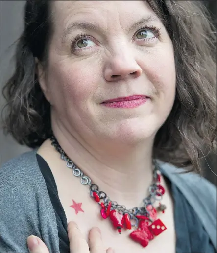  ?? GERRY KAHRMANN/PNG ?? Sonja Larsen, who has written a memoir, Red Star Tattoo — My Life as a Girl Revolution­ary, shows her tattoo and a necklace of red items she has collected in Vancouver on Thursday.