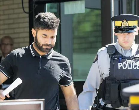  ?? LIAM RICHARDS ?? Jaskirat Sidhu, left, the semi driver charged in connection with the Humboldt Broncos bus crash, leaves court in Melfort on Tuesday after being granted bail. He is subject to conditions, including a curfew and not operating a motor vehicle. The case has been adjourned until August 21.