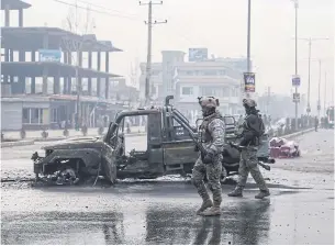  ?? AFP ?? Afghan security personnel stand at the site of an attack in Kabul. Talks to end Afghanista­n’s long running war have been marred by an increase in violence.