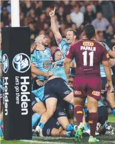  ?? Picture: GETTY IMAGES ?? Blues players celebrate another Origin try.