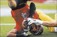  ??  ?? UNLV defensive back Torry McTyer makes one of his two intercepti­ons Saturday on a pass intended for Wyoming wide receiver Jake Maulhardt.