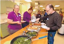  ?? ANDRES LEIGHTON/NMSU ?? Las Cruces Kitchen Creations participan­ts in 2016 enjoy the healthy meal they prepared. Kitchen Creations, a cooking program offered by New Mexico State University’s Cooperativ­e Extension Service, has been featured by the American Diabetes Associatio­n’s Diabetes Support Directory.