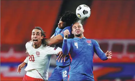  ?? REUTERS ?? England's Tyrone Mings (center) and Kyle Walker contest a header with Denmark's Yussuf Poulsen during England's 1-0 loss in their UEFA Nations League Group A2 match at Wembley Stadium in London on Wednesday.