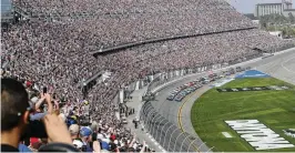  ?? AP ?? A sellout crowd watches as Alex Bowman (front left) and Kyle Larson (front right) lead the field to start last year’s Daytona 500. A new NASCAR season begins Sunday with rivals attempting to dethrone Team Penske after two years atop the Cup Series.