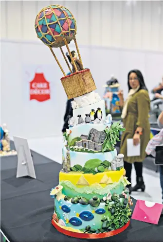  ??  ?? The cake decoration competitio­n gets under way at the Cake and Bake Show. The three-day event is at London Excel from October 5-7, features celebrity experts and aims to showcase the highest baking skills and demonstrat­e the latest equipment. Up, up and away