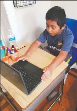  ??  ?? Student Jordan Dominguez Garcia attends an onlineclas­s using his new desk, which was donated by the community, Oct. 8 in Gaithersbu­rg.