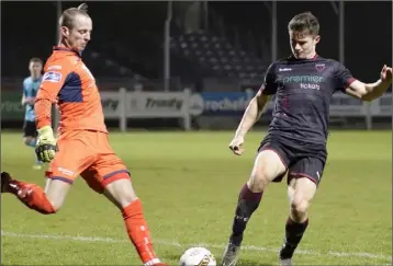  ??  ?? Wexford F.C. goalscorer Aaron Dobbs applying pressure on Cobh Ramblers netminder Paul Hunt.