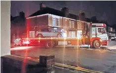  ??  ?? Police tow away a car from the Hull home of Paweł Rełowicz, right, following his arrest