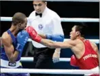  ?? CHANAT KATANYU/BANGKOK POST ?? Thailand’s Wuttichai Masuk (right) lands a punch on Cambodia’s Ratha Ven in the 2015 SEA Games light-welterweig­ht final in Singapore.