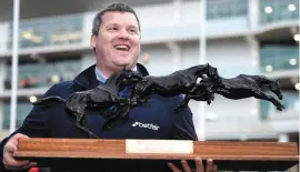  ??  ?? Elliott with his Irish Independen­t Leading Trainer trophy last year