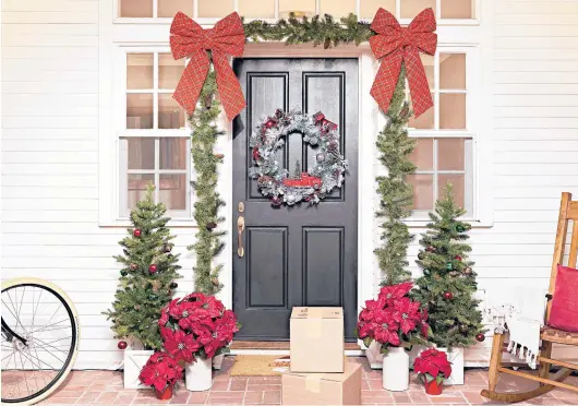  ?? LOWE’S ?? A traditiona­l front door decoration. Frame the front door or wrap a railing with a lighted garland, and add a coordinati­ng wreath, for a cozy, festive vibe. www.lowes.com.