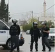  ??  ?? Israeli policemen stand on guard in the village of Arara, Israel, Friday, after a manhunt that put Israelis on edge.