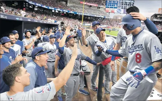  ?? Photograph­s by Wally Skalij Los Angeles Times ?? MANNY MACHADO (8) arrives at a jubilant Dodgers dugout after his three-run home run in the seventh inning. Says Machado: “It was just an unbelievab­le feeling.”