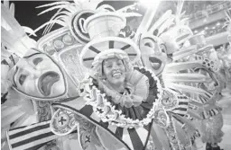  ?? WAGNER MEIER/GETTY ?? Members of Sao Clemente samba school perform during the Rio de Janeiro 2022 Carnival at Marques de Sapucai Sambodrome on Saturday in Brazil.